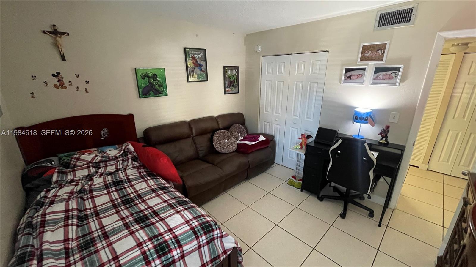 1805 West 56th Street, Unit 113 Hialeah, FL 33012 - Photo 8 of 11 a living room with furniture and a window