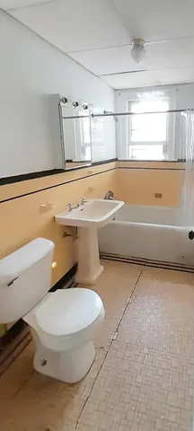 a bathroom with a toilet and a bathtub