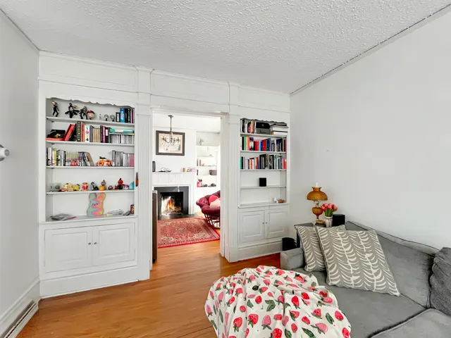a bedroom with furniture and a wooden floor