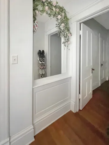 a view of closet with wooden floor