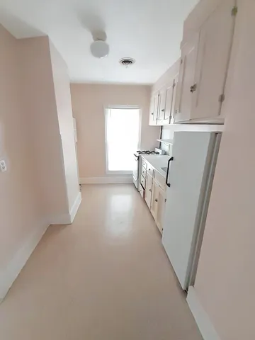 a bathroom with a sink a toilet a mirror and bathtub