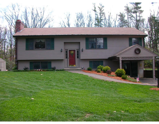 12 Crooks Road North Brookfield, MA 01535 - Photo 1 of 16 a front view of a house with a yard table and chairs