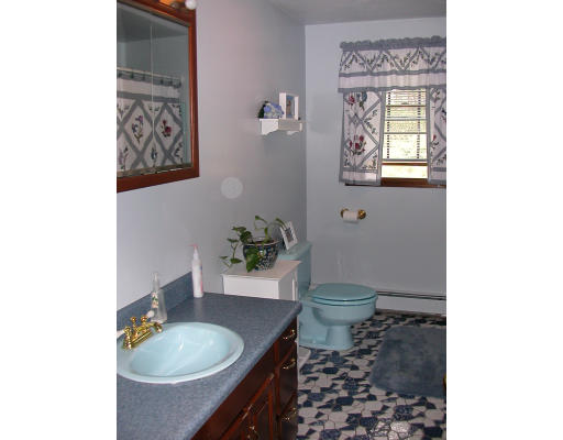 12 Crooks Road North Brookfield, MA 01535 - Photo 11 of 16 a bathroom with a granite countertop toilet a sink and a mirror