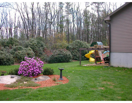 12 Crooks Road North Brookfield, MA 01535 - Photo 4 of 16 a view of a backyard with plants and a fountain