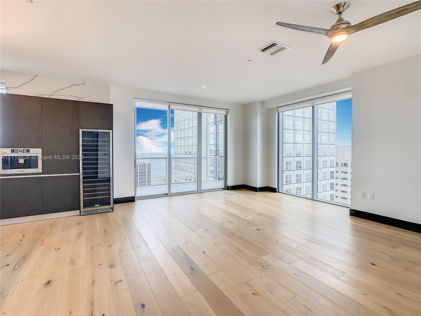 340 Southeast 3rd Street, Unit PH2 Miami, FL 33131 - Photo 14 of 54 a view of an empty room with wooden floor and a window