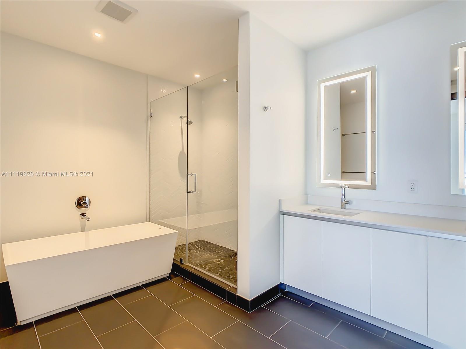 340 Southeast 3rd Street, Unit PH2 Miami, FL 33131 - Photo 19 of 54 a bathroom with a bathtub and a sink