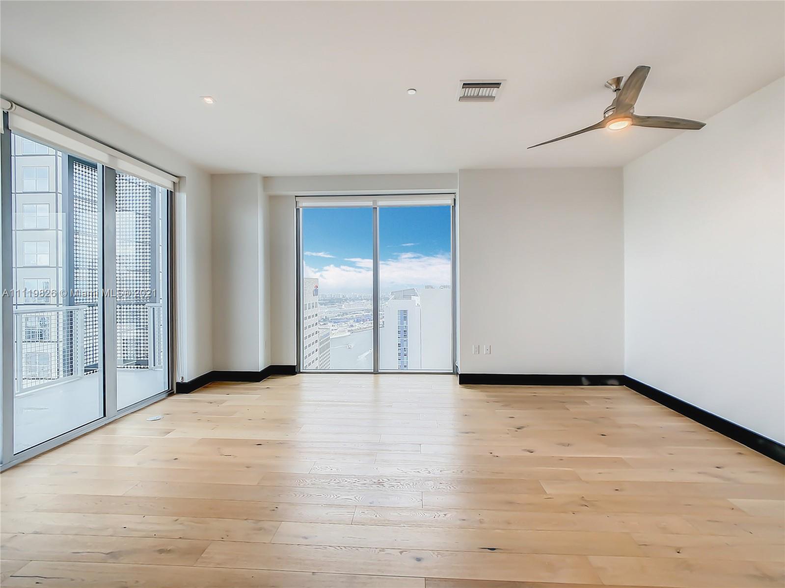 340 Southeast 3rd Street, Unit PH2 Miami, FL 33131 - Photo 3 of 54 a view of an empty room with glass door
