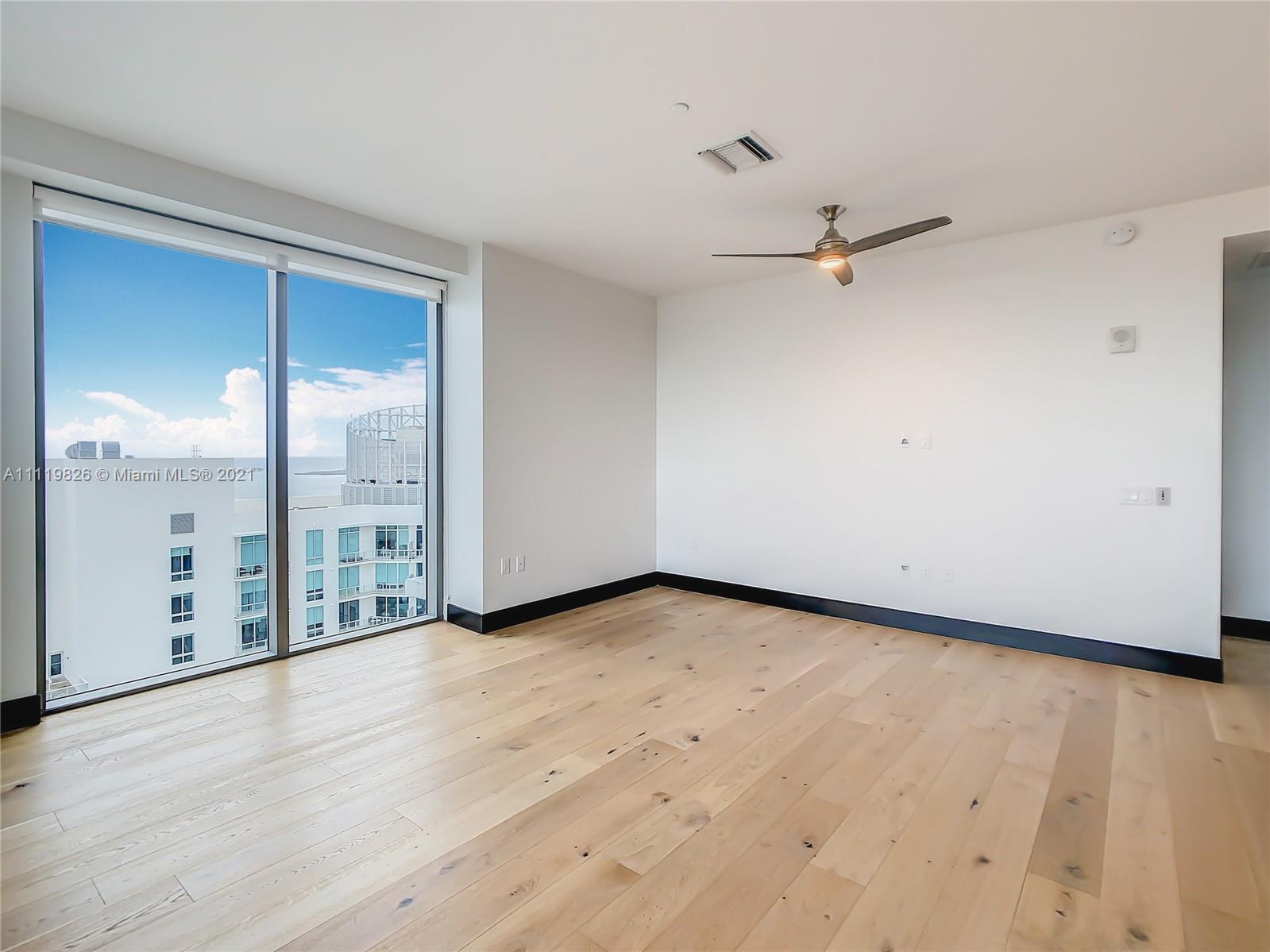 340 Southeast 3rd Street, Unit PH2 Miami, FL 33131 - Photo 4 of 54 wooden floor in an empty room