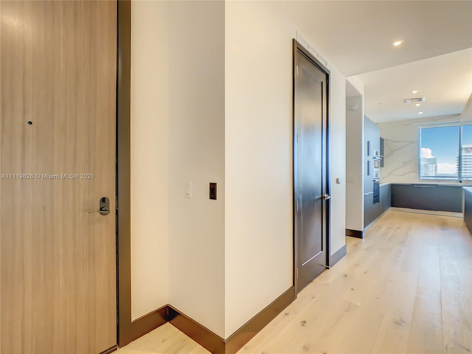 340 Southeast 3rd Street, Unit PH2 Miami, FL 33131 - Photo 10 of 54 a view of hallway with wooden floor