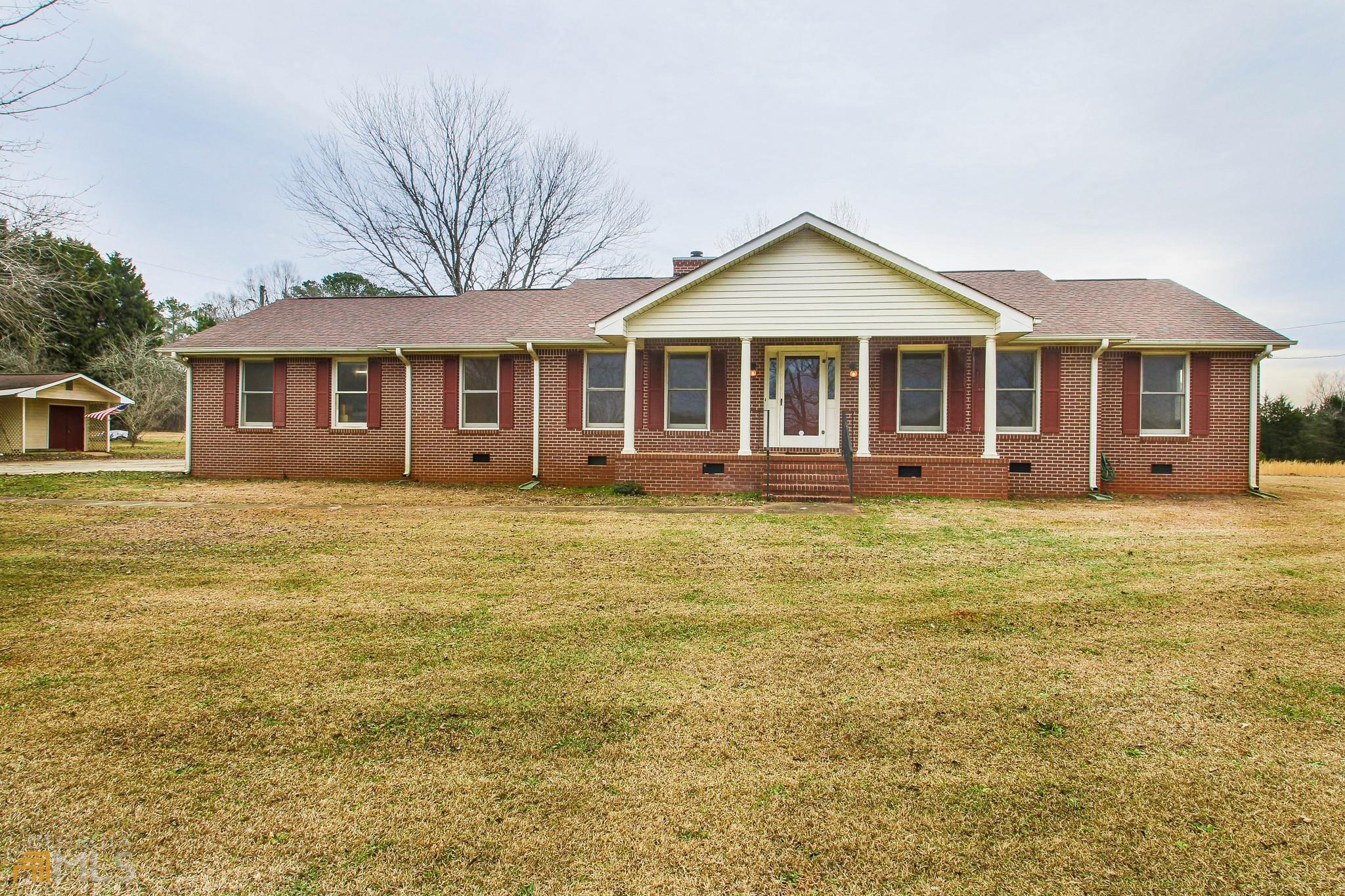 286 Moon Road Griffin, GA 30223 - Photo 1 of 1 a front view of a house with a garden