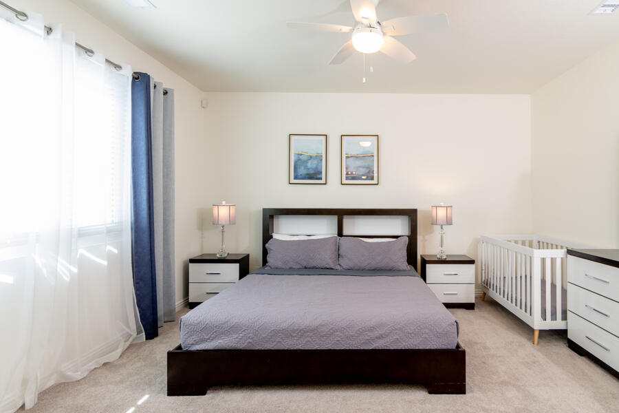43784 Riunione Place Indio, CA 92203 - Photo 13 of 54 a bedroom with a bed and a chandelier