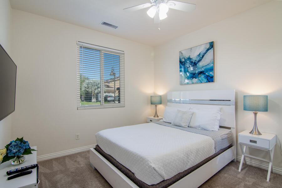 43784 Riunione Place Indio, CA 92203 - Photo 17 of 54 a bedroom with a bed and a painting on the wall