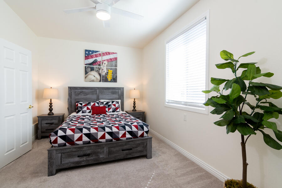 43784 Riunione Place Indio, CA 92203 - Photo 20 of 54 a bedroom with a bed flowers and a potted plant