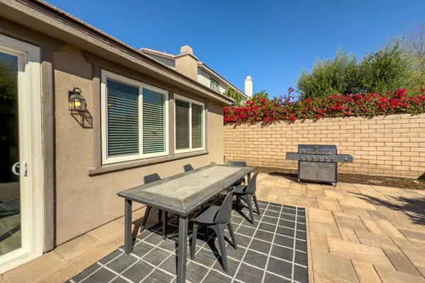 a view of a patio with table and chairs and potted plants