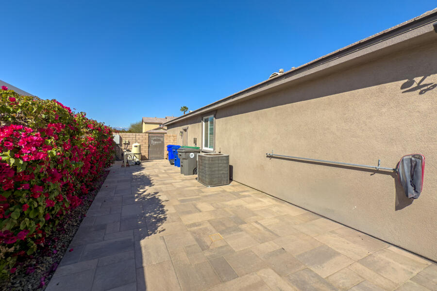 43784 Riunione Place Indio, CA 92203 - Photo 31 of 54 a view of a patio with table and chairs and potted plants