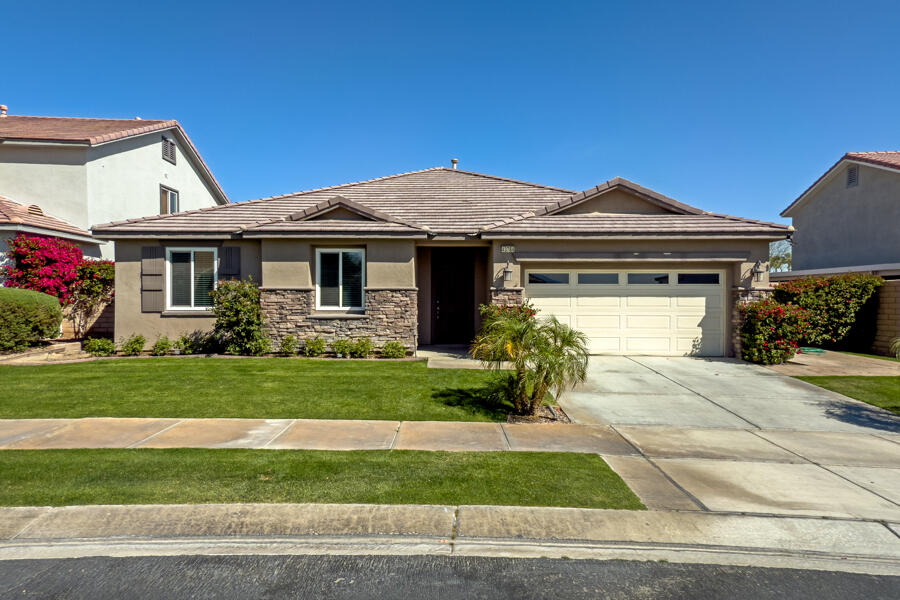 43784 Riunione Place Indio, CA 92203 - Photo 36 of 54 a front view of a house with a yard and garage