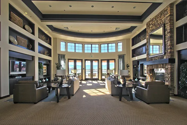 a living room with a table chairs and a window