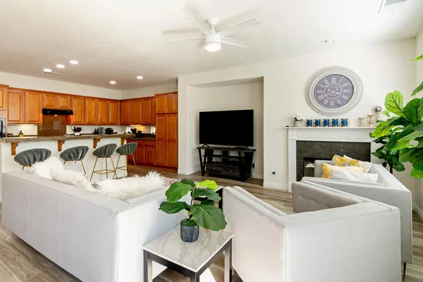 a kitchen with a table chairs sink and wooden floor