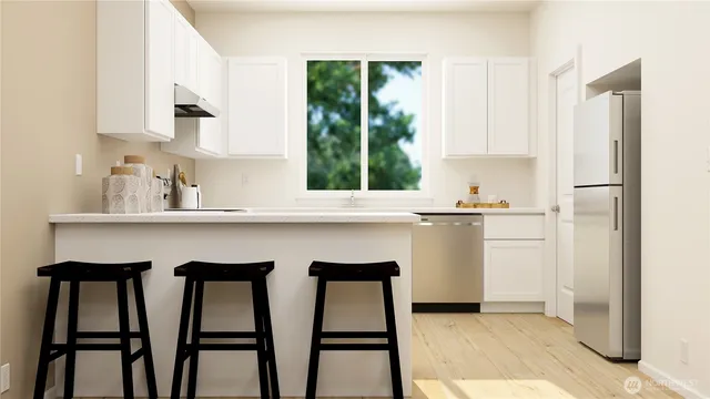 a kitchen with appliances cabinets and a window