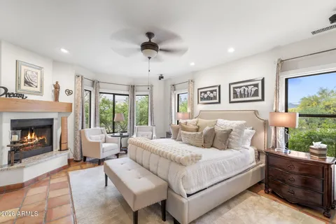 a large bedroom with a bed and a flat screen tv
