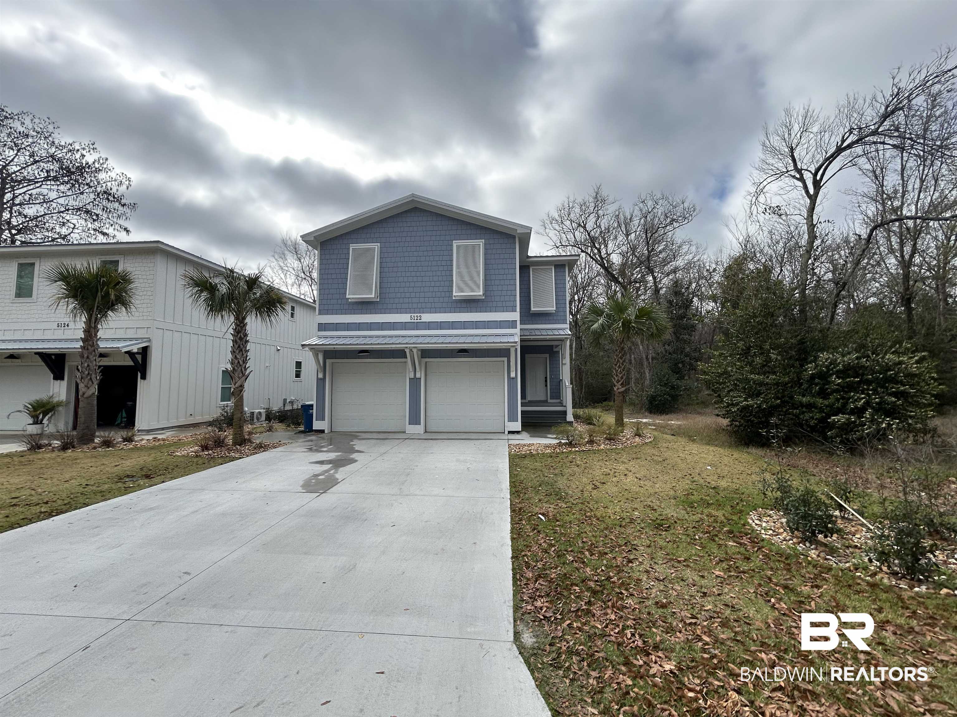 5122 Pine Road Orange Beach, AL 36561 - Photo 1 of 24 Traditional home with a garage, concrete driveway, and a front yard