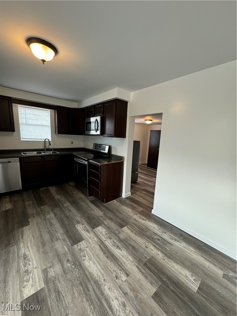 5155 Center Road Philo, OH 43771 - Photo 10 of 37 Kitchen featuring dark hardwood / wood-style floors, sink, dark brown cabinetry, and stainless steel appliances