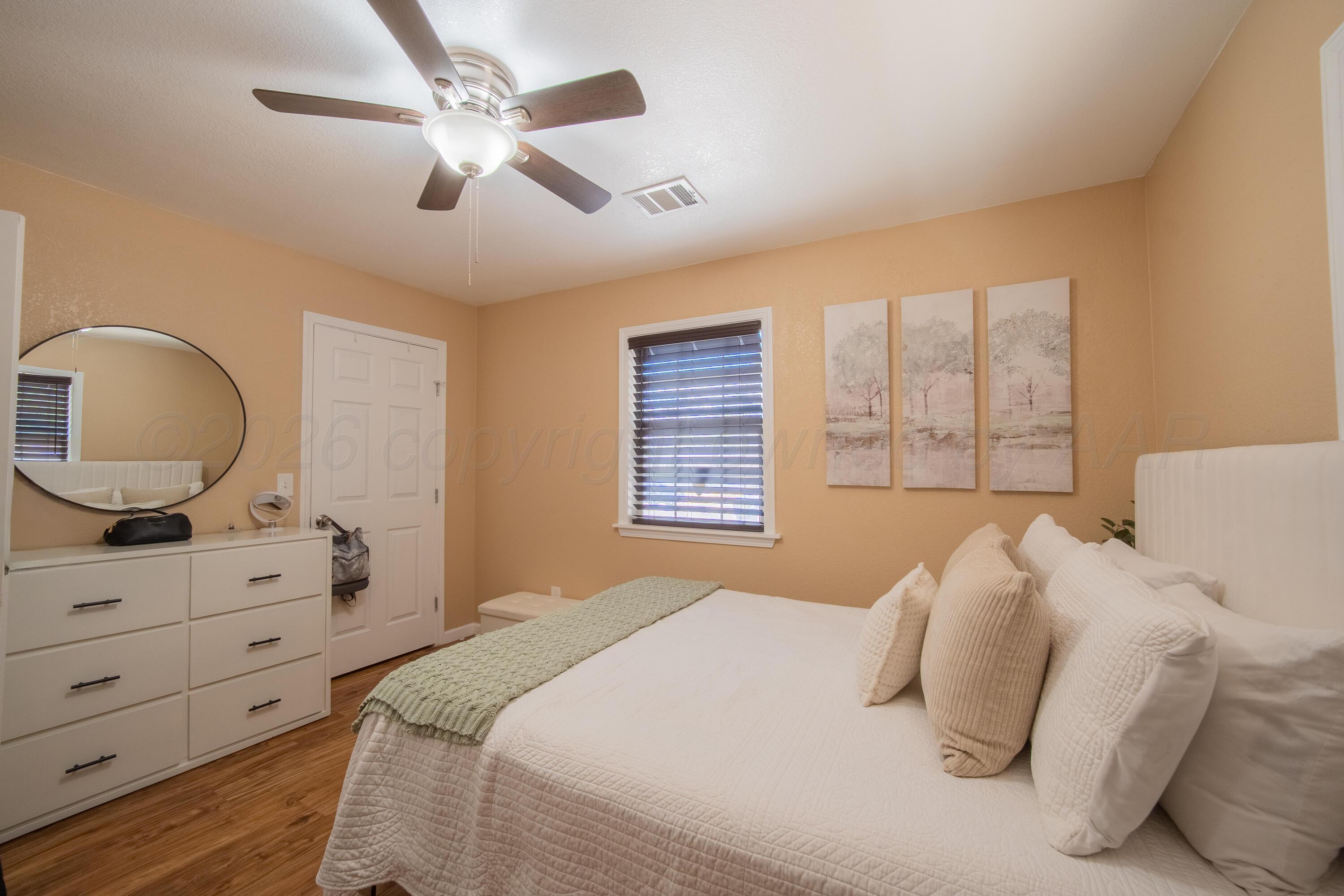 4014 Gables Street Amarillo, TX 79110 - Photo 8 of 14 a bedroom with a large bed and a dresser
