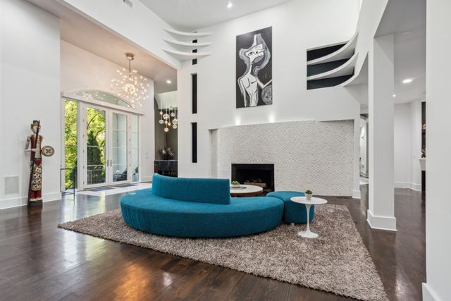 a large kitchen with a large counter top space a sink stainless steel appliances and cabinets