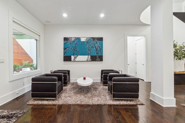 a dining room with furniture a chandelier and wooden floor