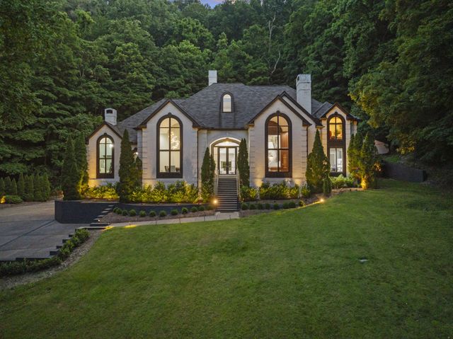 a front view of a house with garden