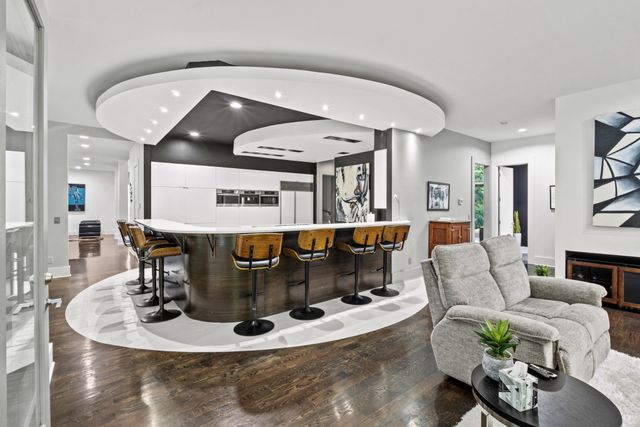 a front view of a house with a yard and potted plants