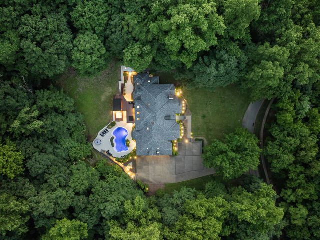 an aerial view of a house with outdoor space swimming pool and lake view