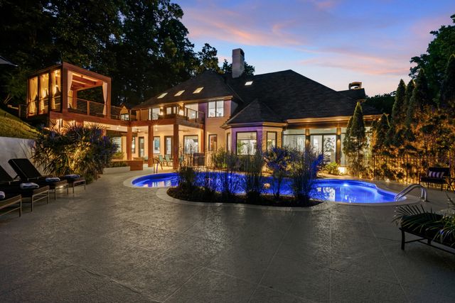a view of a house with backyard porch and sitting area