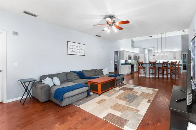 a living room with furniture and wooden floor