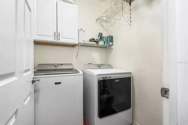 a view of the house with backyard and sitting area