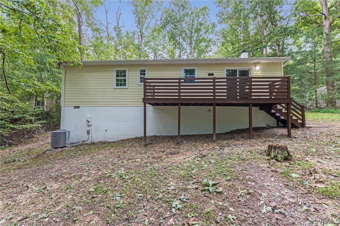 10200 Edgecliff Lane Chesterfield, VA 23832 - Photo 25 of 25 a view of a wooden house with a yard and large trees