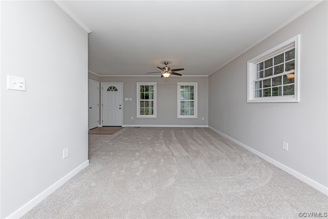 10200 Edgecliff Lane Chesterfield, VA 23832 - Photo 8 of 25 an empty room with windows and chandelier