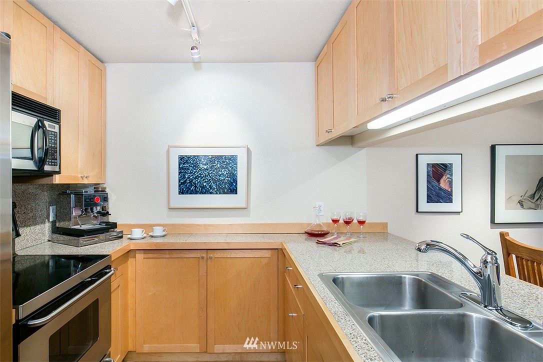 275 West Roy Street, Unit 319 Seattle, WA 98119 - Photo 4 of 18 a kitchen with a sink cabinets and appliances