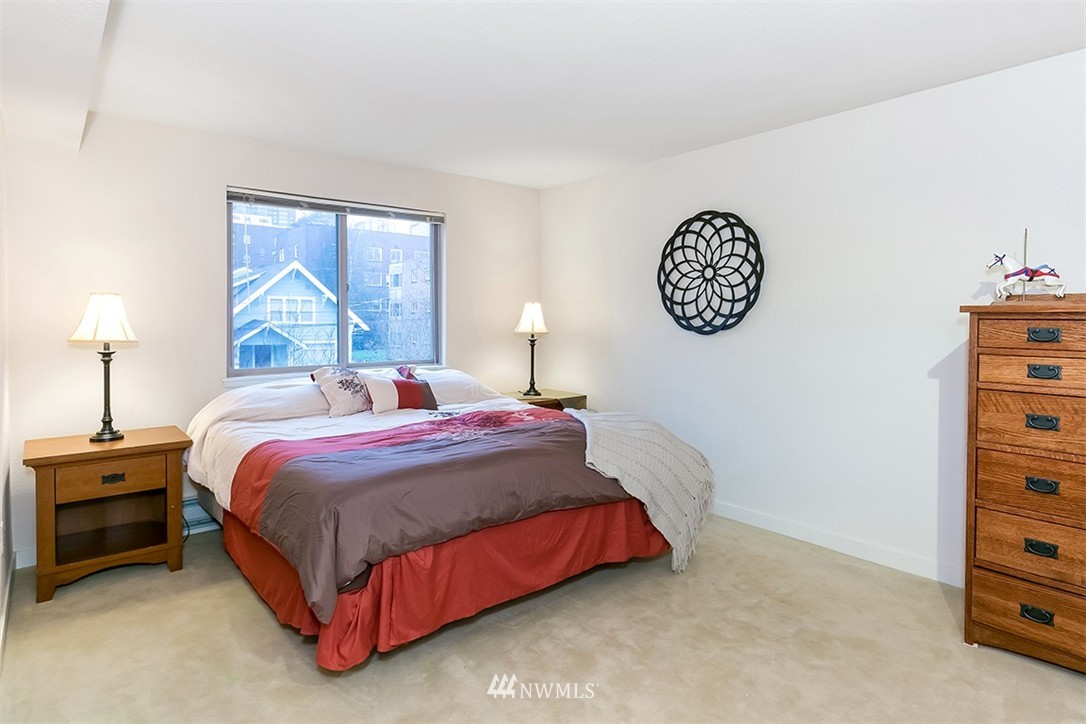 275 West Roy Street, Unit 319 Seattle, WA 98119 - Photo 7 of 18 a bedroom with a bed and a table