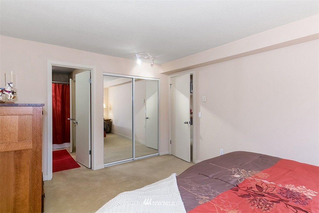 275 West Roy Street, Unit 319 Seattle, WA 98119 - Photo 8 of 18 a bedroom with a bed and a shower