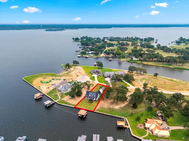 an aerial view of a house with a swimming pool patio and outdoor seating