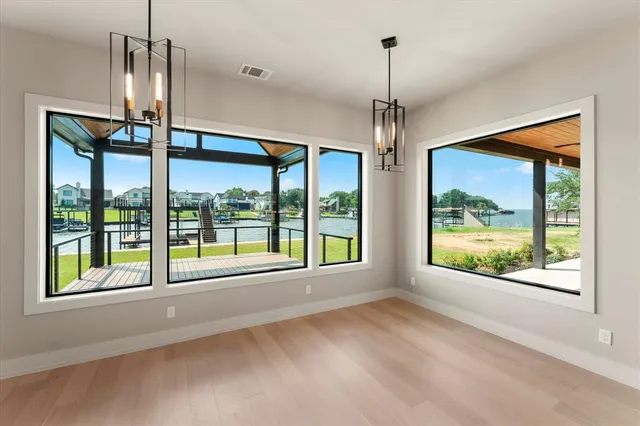 a view of an empty room with windows and a balcony