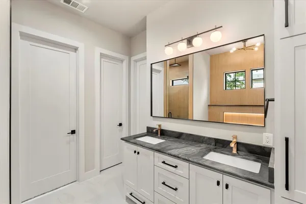 a bathroom with a granite countertop sink a mirror and a