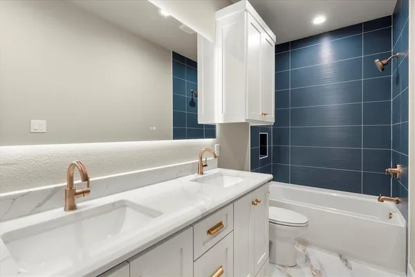a bathroom with a sink a toilet and bathtub
