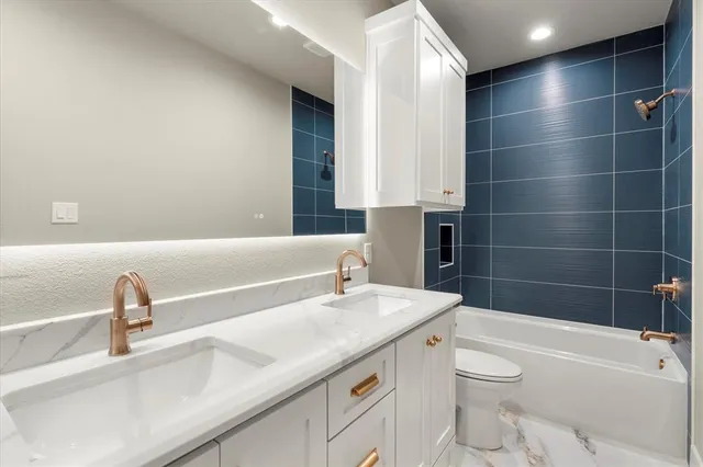 a bathroom with a sink a toilet and bathtub