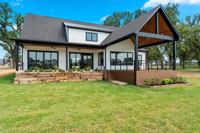 a view of a house with swimming pool and sitting area