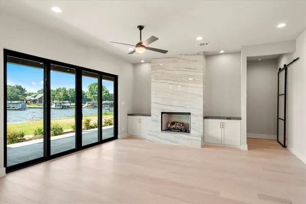 a view of an empty room with a fireplace and a large window
