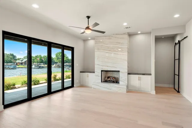 a view of an empty room with a fireplace and a large window