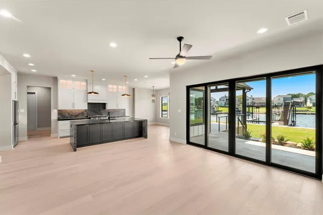 a large room with a large window and stainless steel appliances