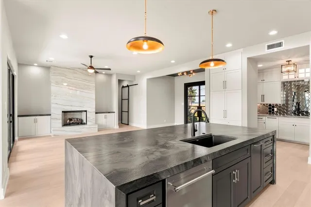 a kitchen with a sink a counter space and stainless steel appliances